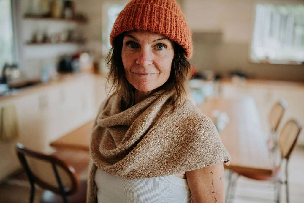 Woman wearing a beige scarf.