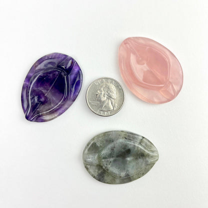 A amethyst vulva worry stone.