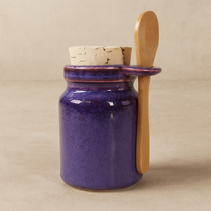 Purple ceramic jar with a wooden spoon.