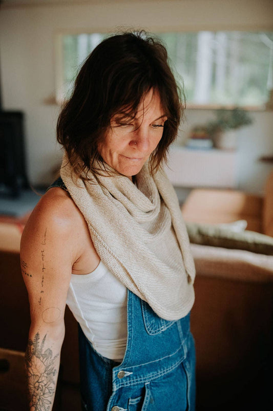 Woman wearing a beige shawl.
