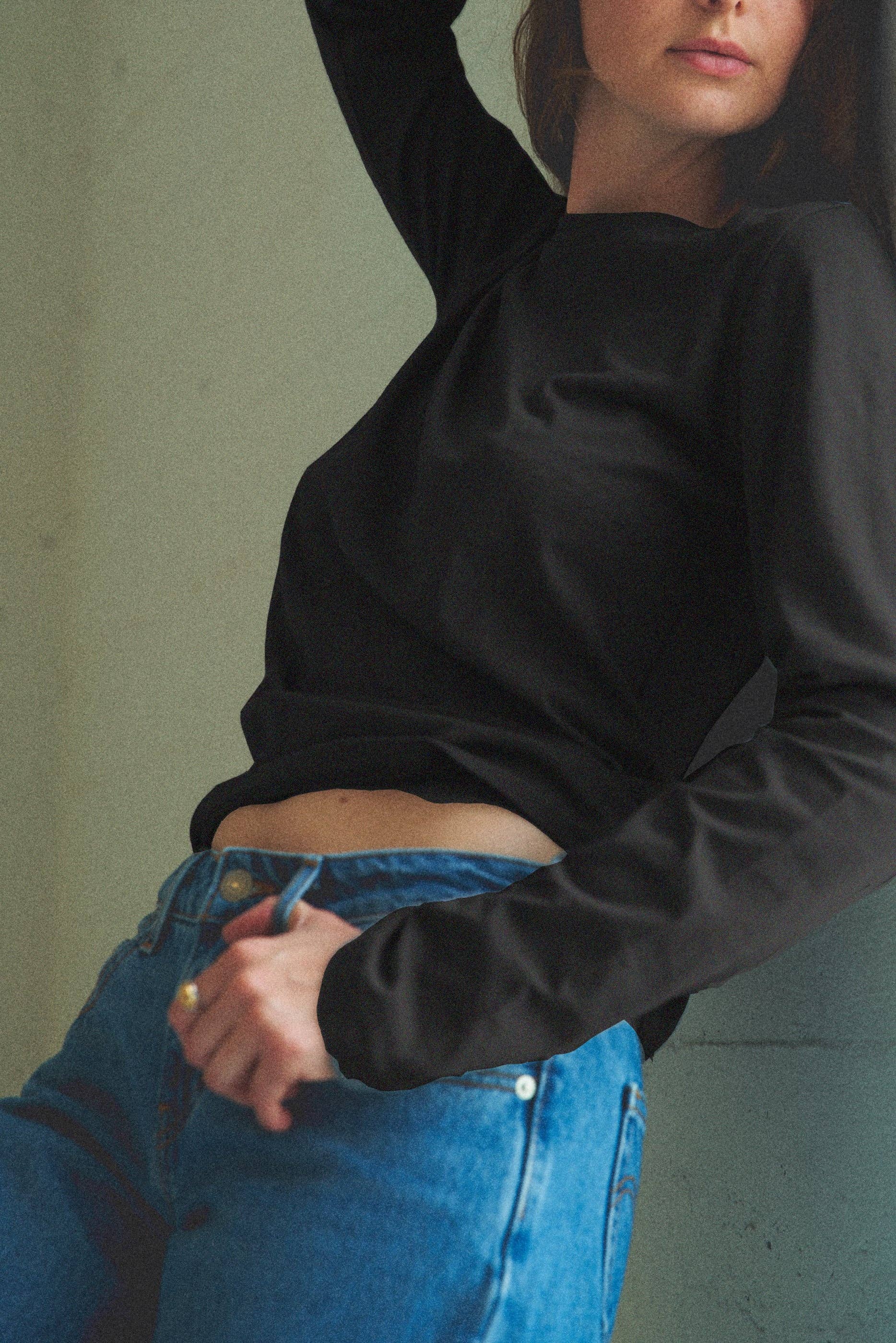 Woman wearing a black long-sleeve organic cotton top.