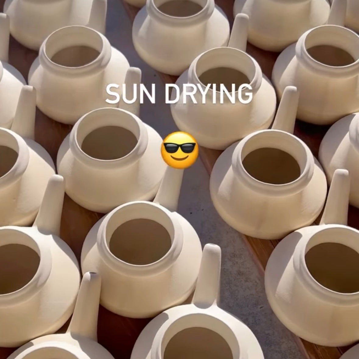 White ceramic neti pots drying in the sun.