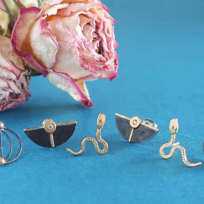 Lightweight real gold viper stud earrings.