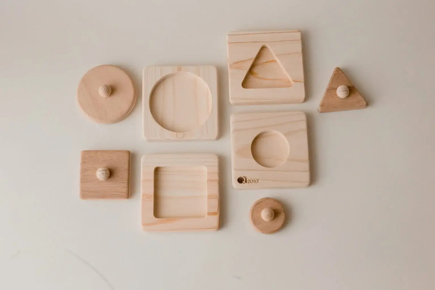 Set of four wooden geometric shaped puzzles.