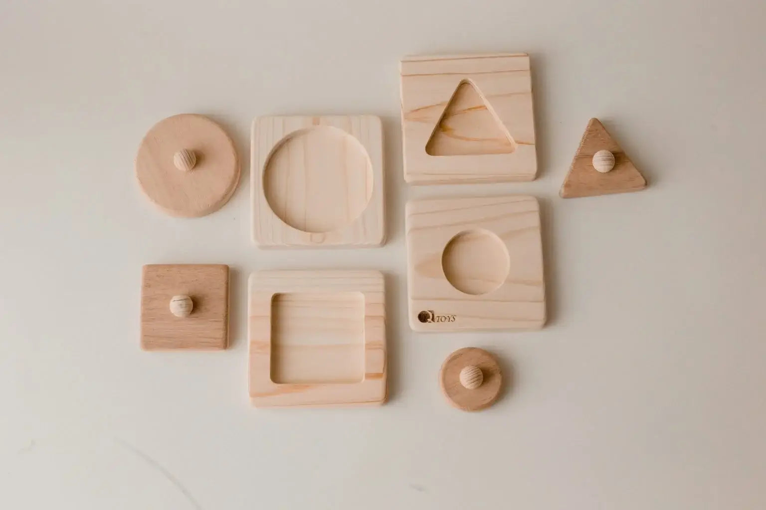 Set of four wooden geometric shaped puzzles.