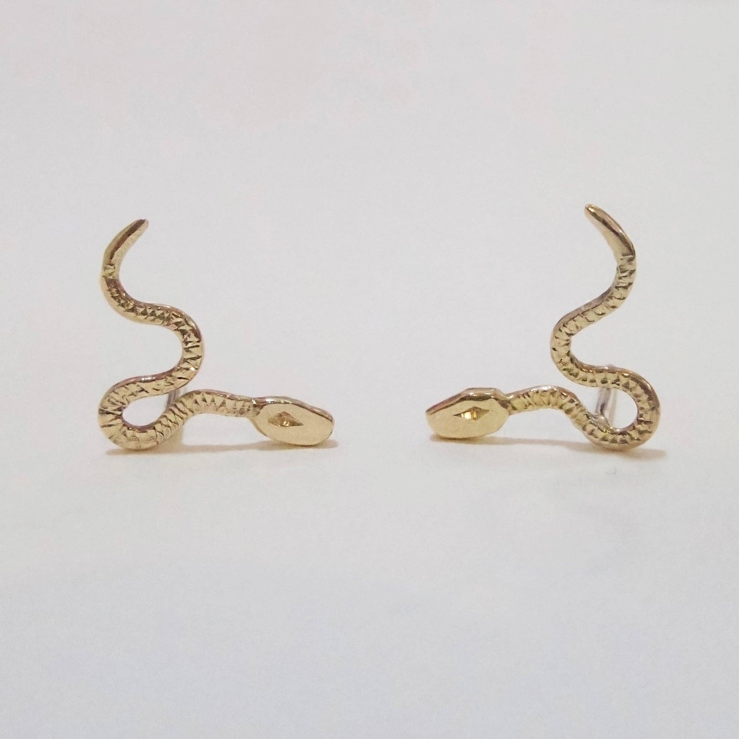 10K mini Gold viper-shaped earrings.