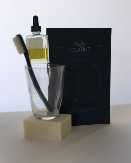  A black notebook titled 'The Night Routine Journal'.