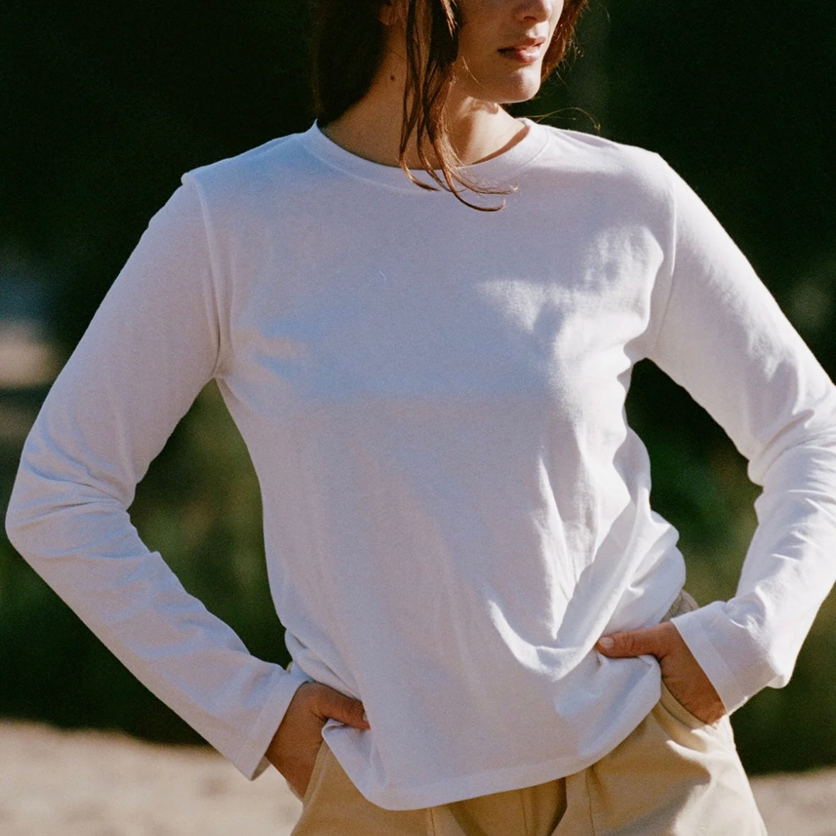 Woman wearing a white California-grown-cotton long-sleeve shirt.