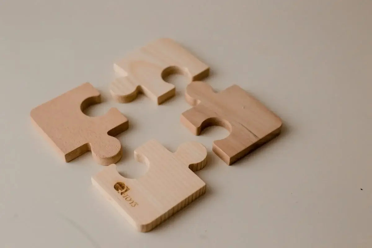 Four beige montessori puzzle pieces.