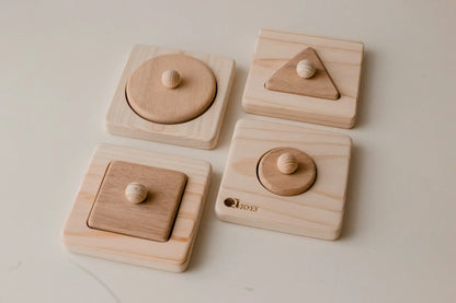 Set of wooden puzzles with geometric shapes.