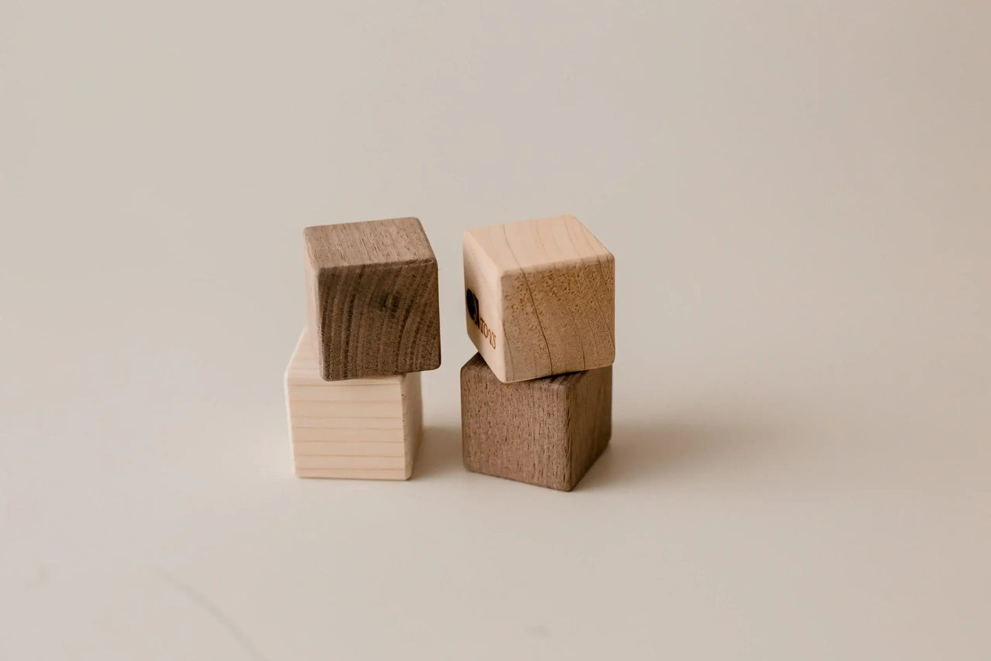 Four stacking wooden blocks.