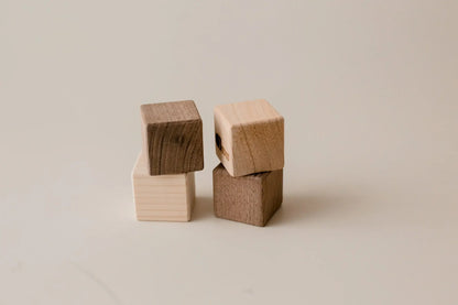 Four stacking wooden blocks.