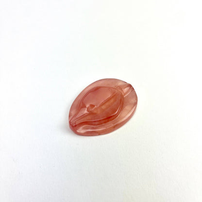Rose quartz vulva shaped worry stone.