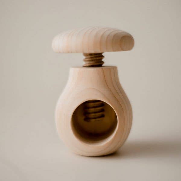 A wooden screw-top mushroom toy for toddlers.
