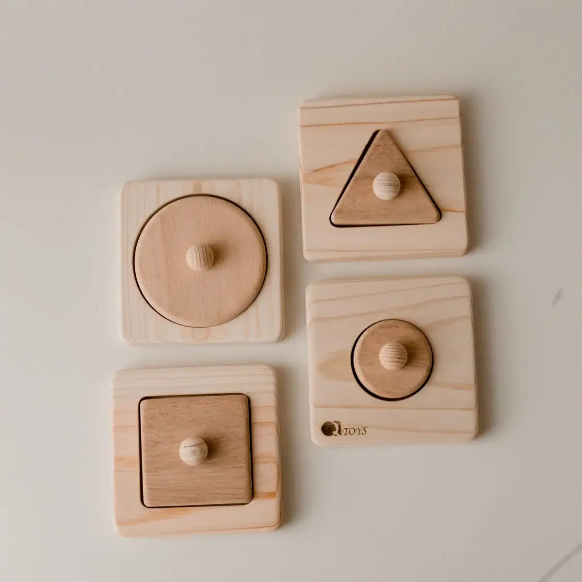 Set of four wooden shaped puzzle set.