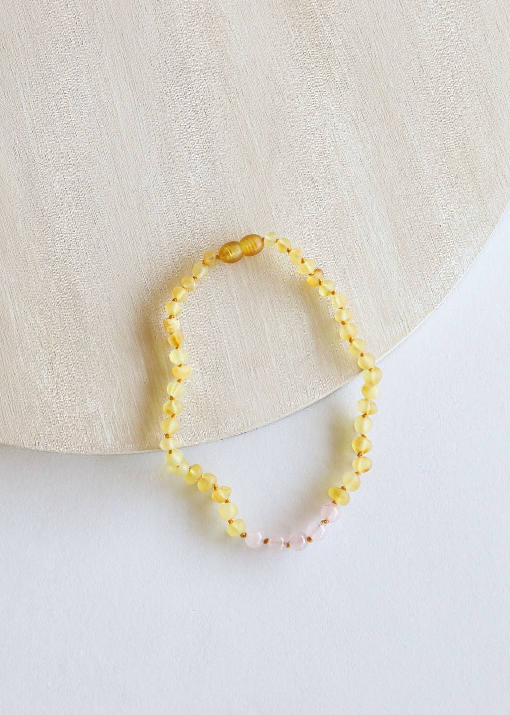 Raw Baltic amber and rose quartz necklace for babies.