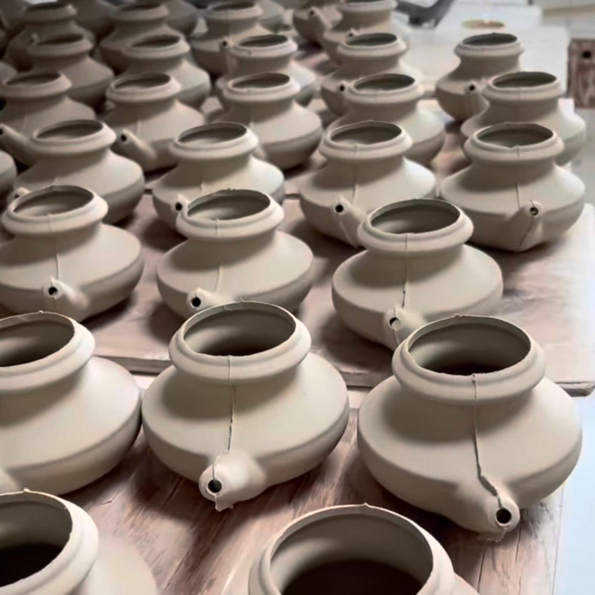 Row of ceramic neti pots.
