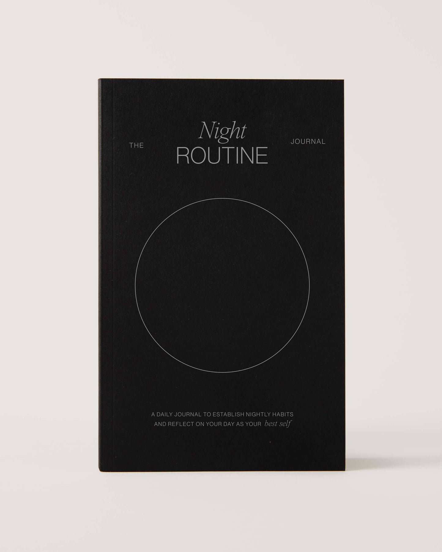 Black notebook titled 'The Night Routine Journal' 