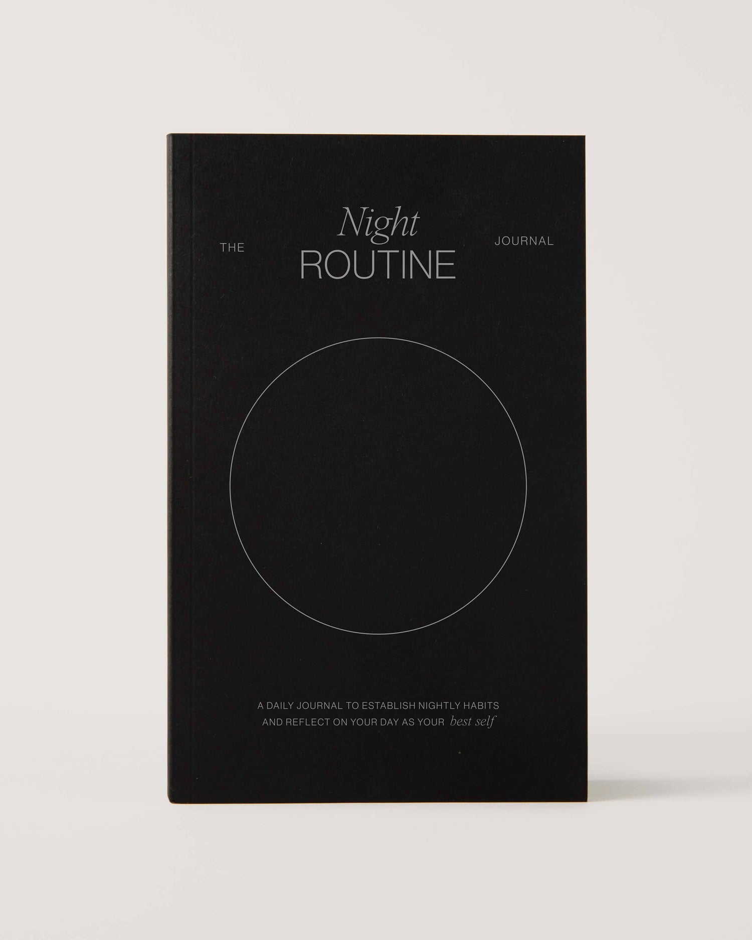 Black notebook titled 'The Night Routine Journal' 