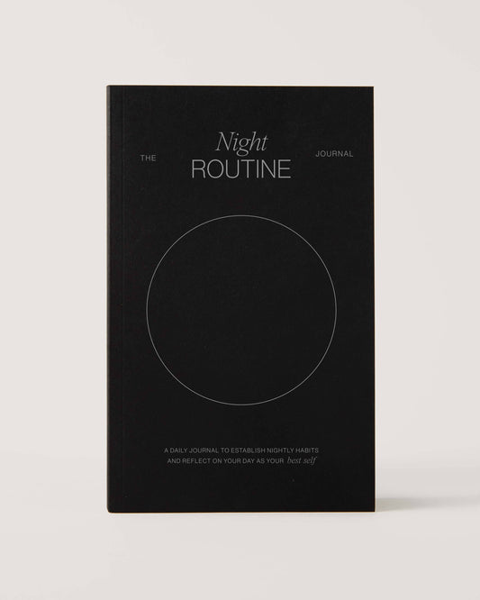 Black notebook titled 'The Night Routine Journal' on white background