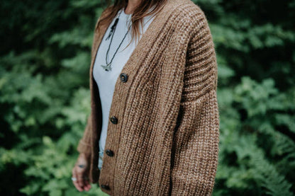 Woman wearing a brown knitted wool cardigan.