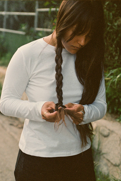 Woman wear white long sleeve tee shirt.