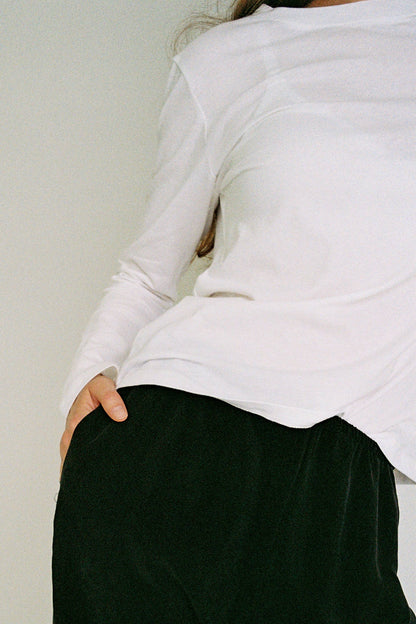  A white long-sleeve top.